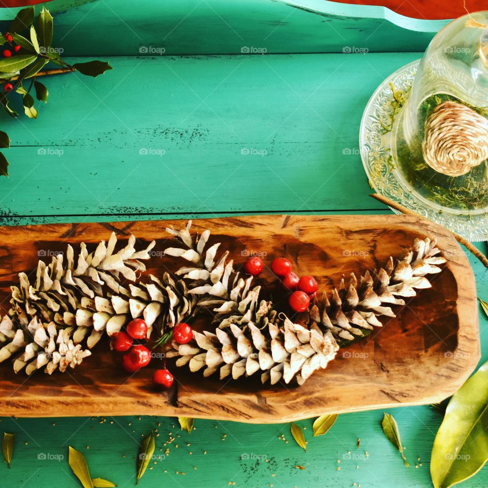 Nature’s best tablescape with pine cones and holly berries