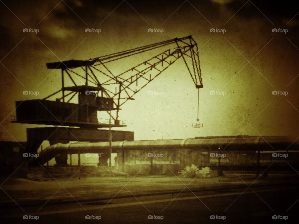 Industrial crane loading cargo at a seaport