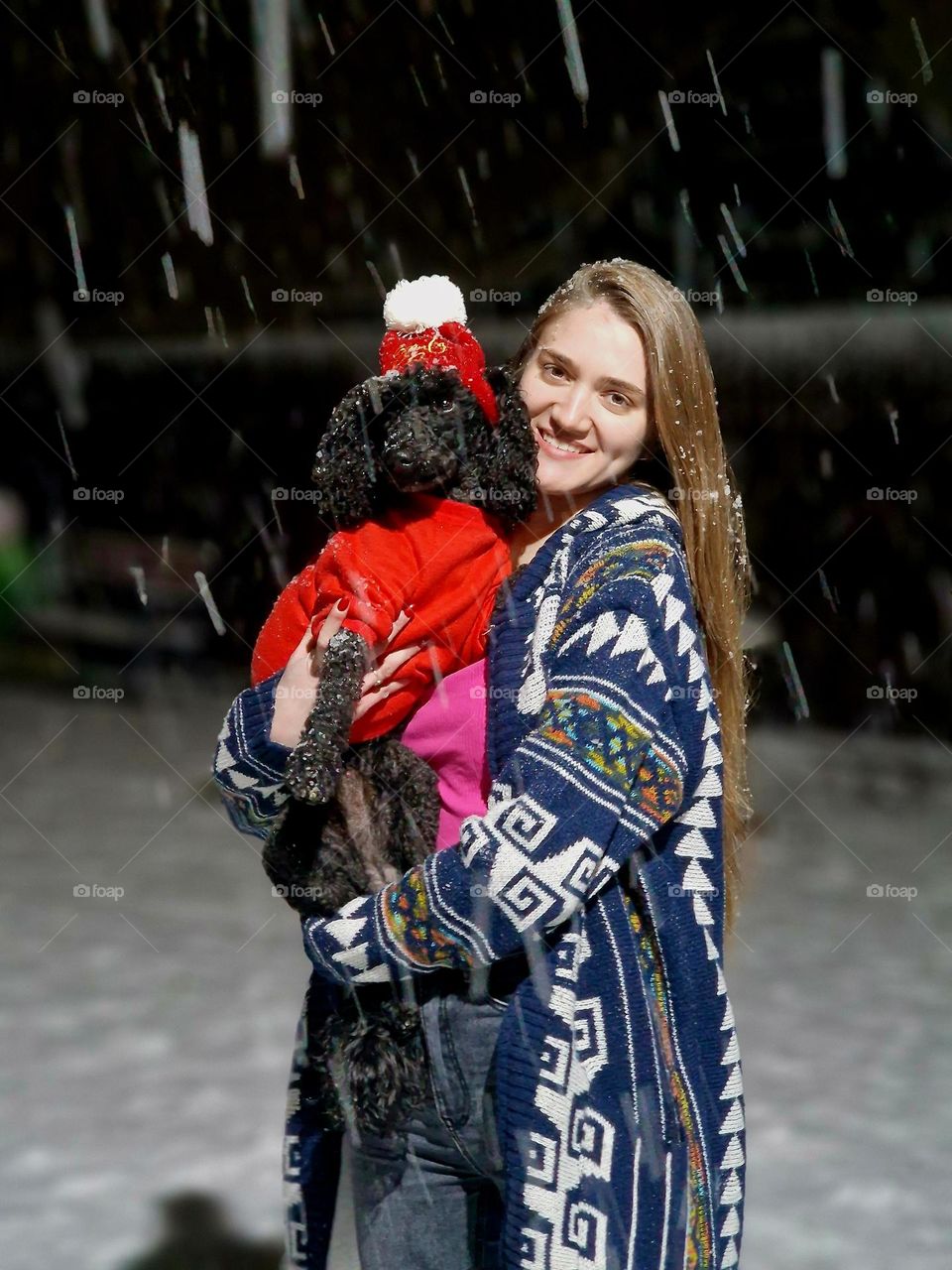 pretty girl with her dog on the snow