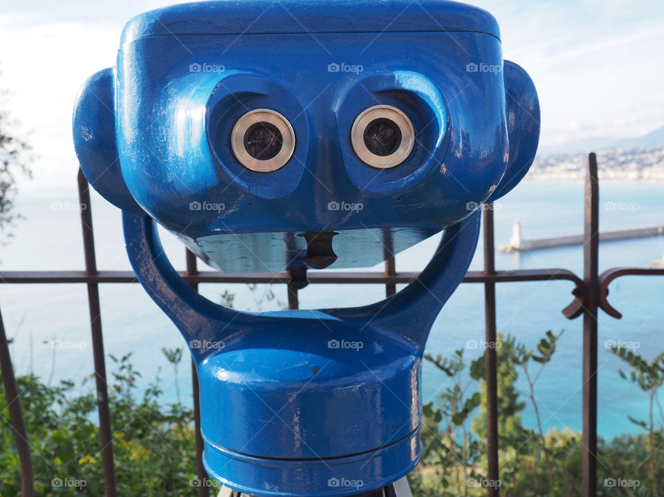 Blue coin operated binoculars overlooking the city of Nice, France.
