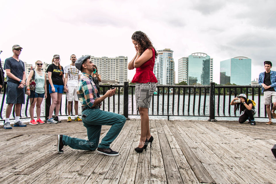 Man proposing woman near sea