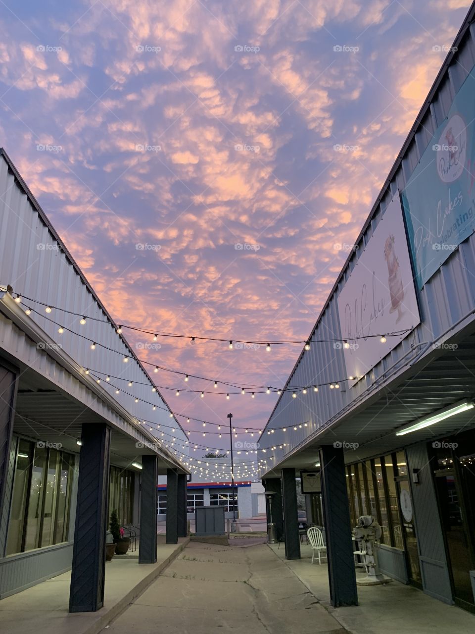 Sunset clouds light up a empty storefront 