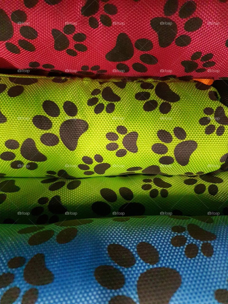 Colorful Fabric Rolls with Black Paw Print Pattern