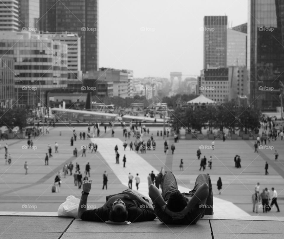 Two men relaxing in the business district of La Défense, Paris, France