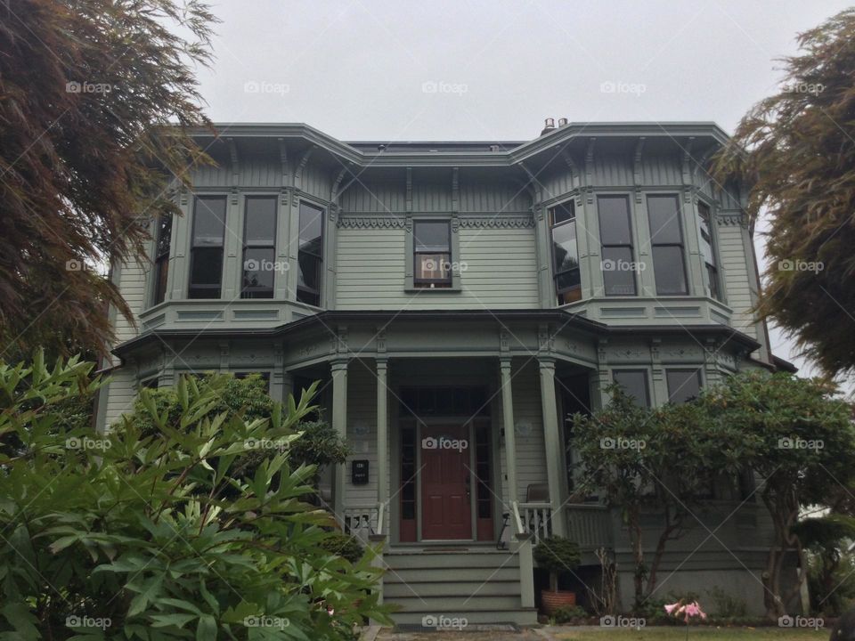 Victorian Era Home with a porch and columns providing support 