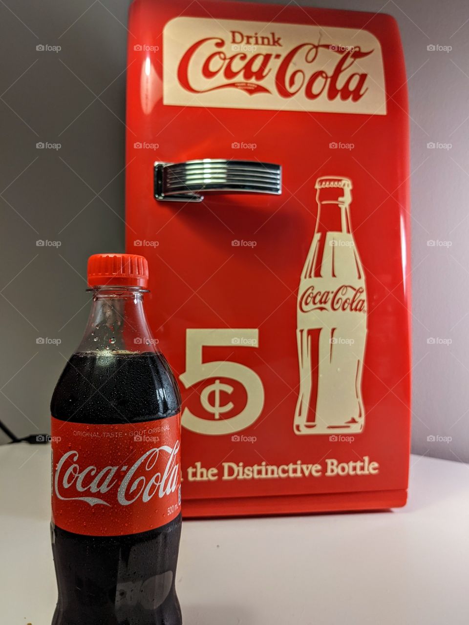 Coke bottle with Coca-Cola vintage mini fridge