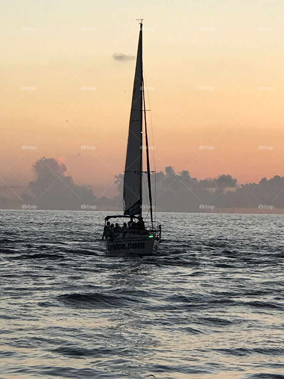 Sailboat in silhouette at sunset 