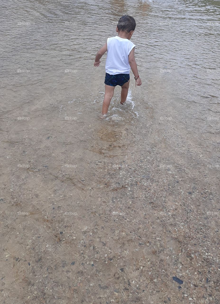 cute child in rainy water