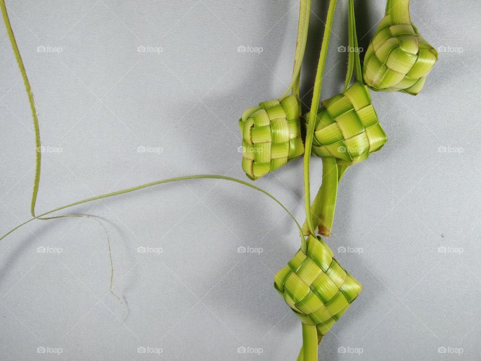 ketupat,  from woven coconut leaf. traditional food from Indonesia. filled with rice before cooking. for decoration too