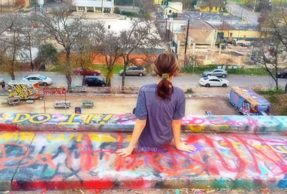 Graffiti park. my daughter sitting high on a wall at Graffiti Park in Austin