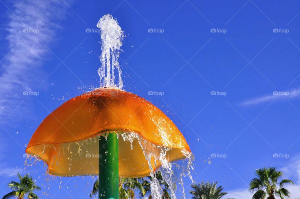 A orange water spout at a water park. 