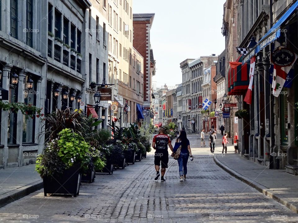 Old Montreal , quaint cobble stone  street, beautiful architecture, pedestrian street , romantic couple walking 