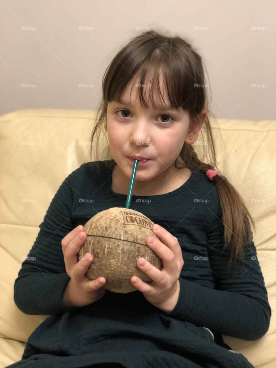 Little girl drinking coconut 