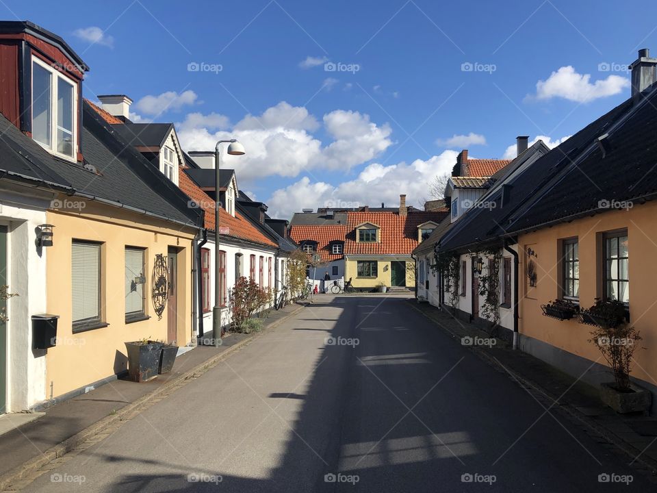 Neighborhood, street on a sunny day with blue sky