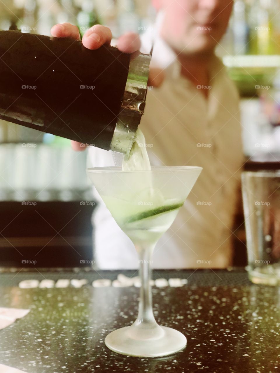 Cucumber martini being poured after a long day at work. 