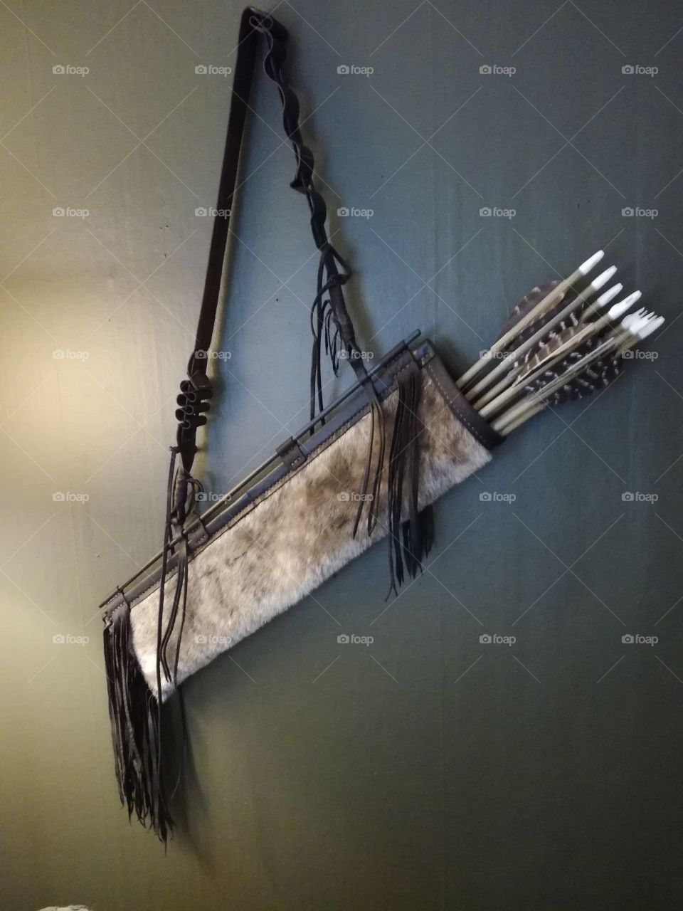 Quiver with arrows hanging on wall. Leathercraft handmade vintage