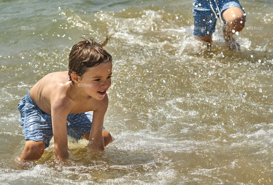 Boy playing in the water at beach