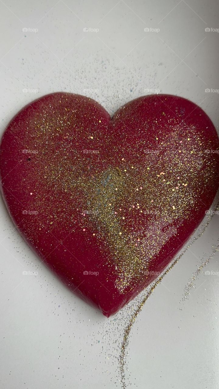 They made red slime in the shape of a heart and poured acrylic on it