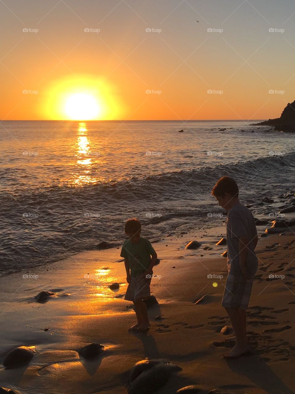 My boys playing on the beach at sunset.