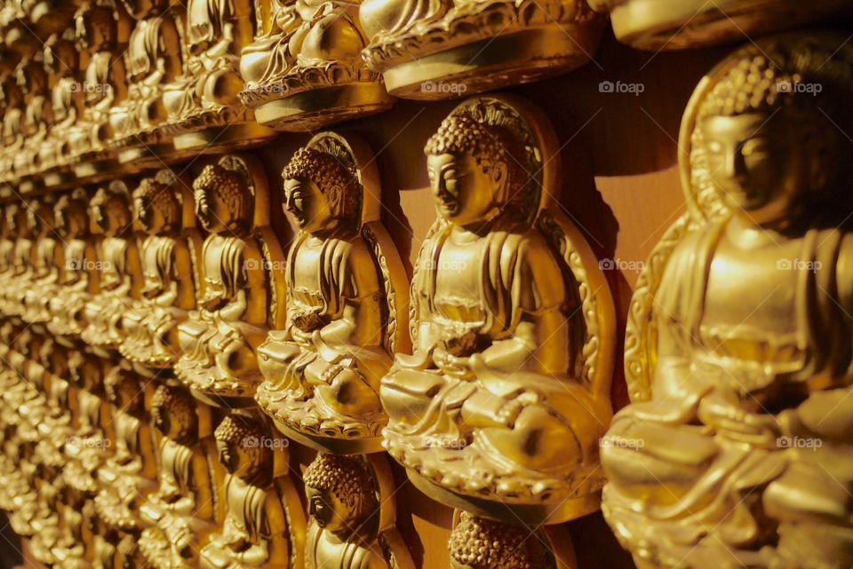 Golden amita buddha statue. Golden amita buddha statue on the wall