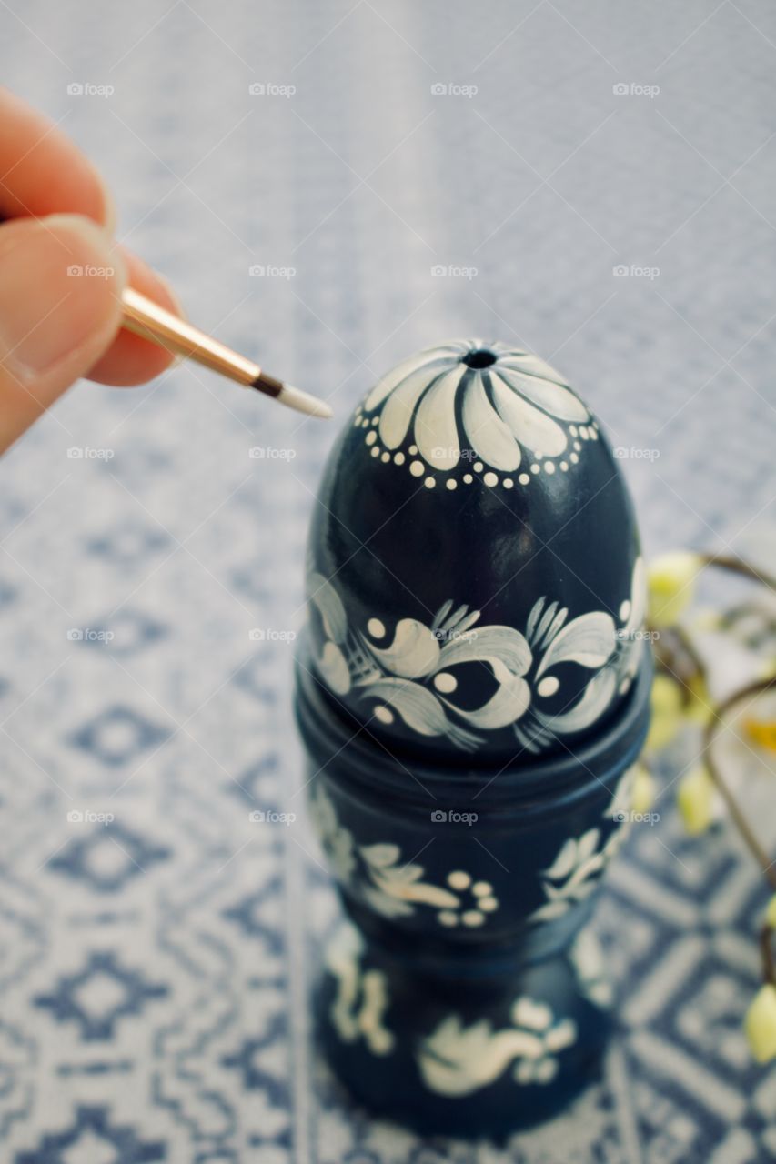 Painting an egg for Easter 