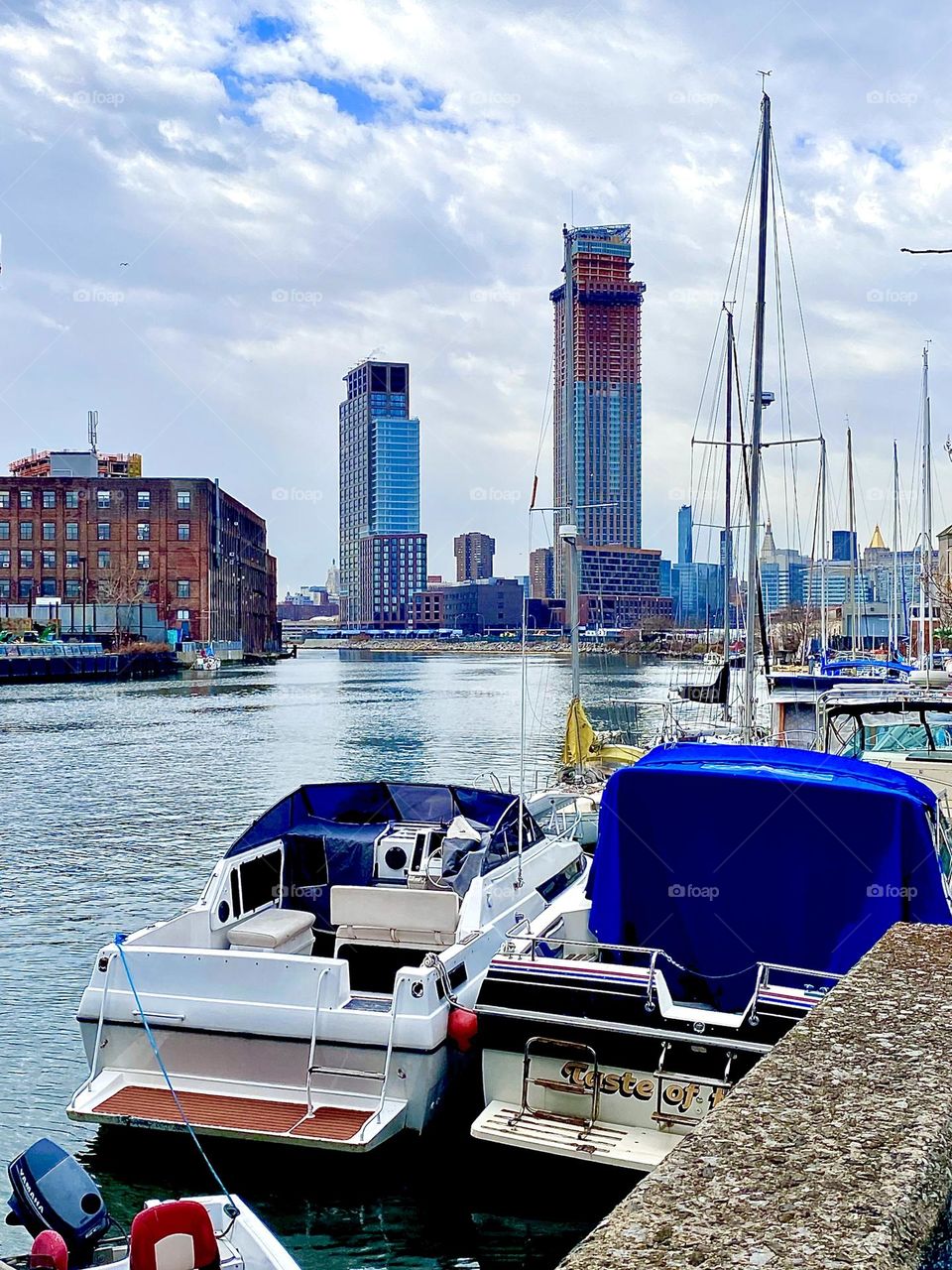 View of Newtown Creek with its large variety of different boats from the parking lot underneath the Pulaski Bridge on a partially overcast afternoon in late December 2021. Hypnotic Productions