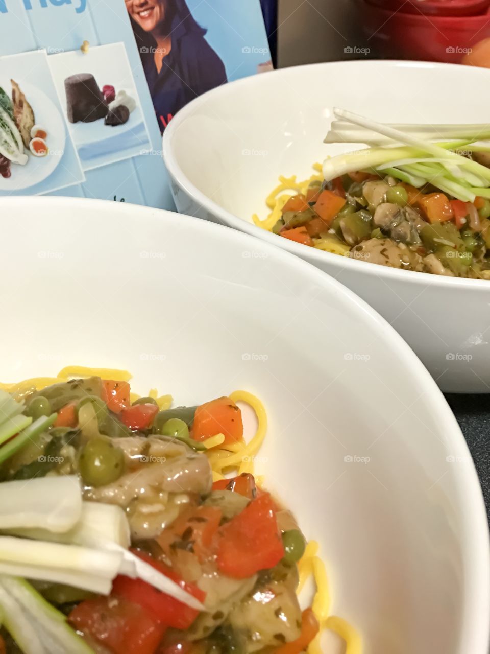 Thai Basel chilli chicken and vegetables in white bowl and chopsticks closeup Asian food 