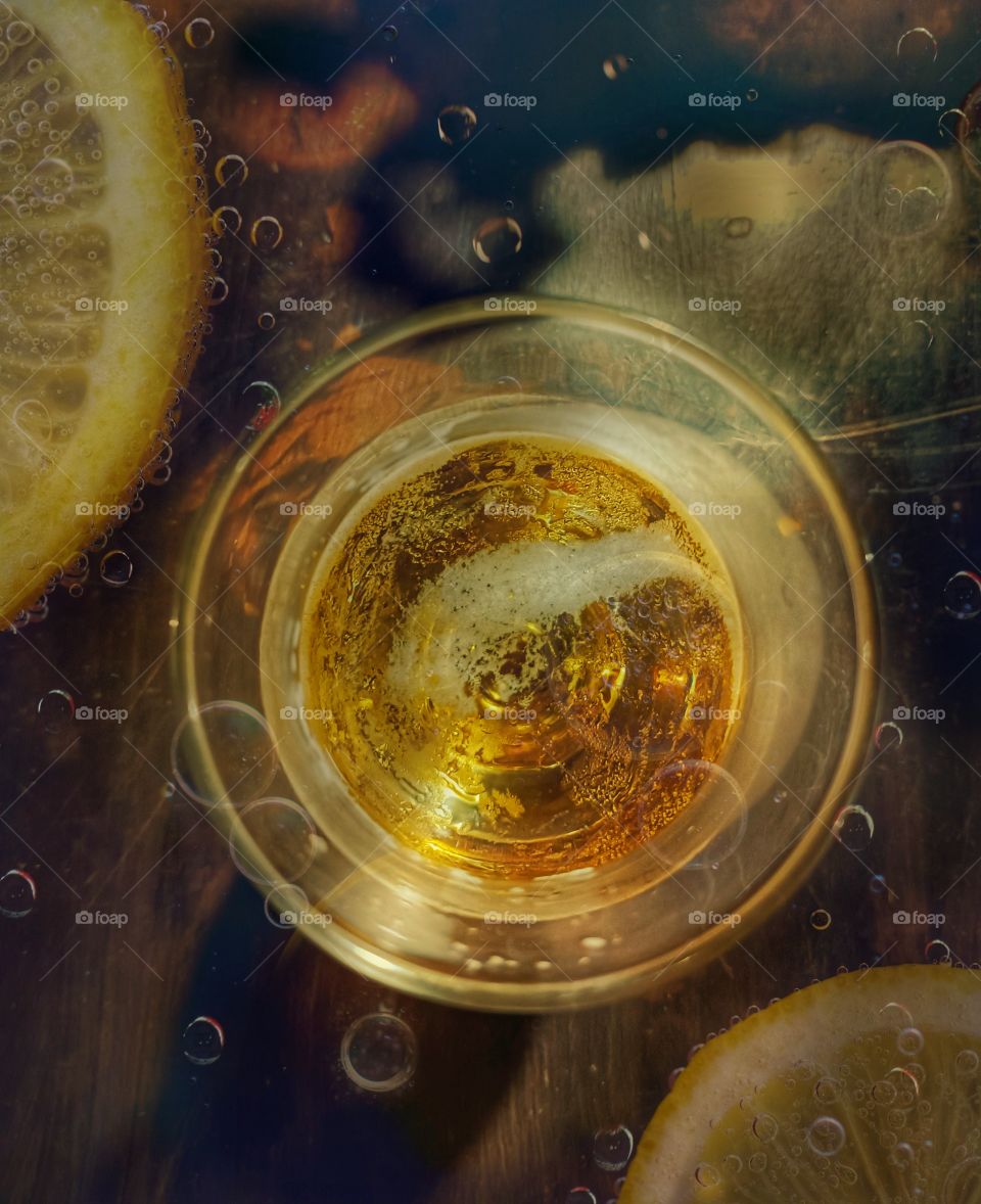 Beer glass viewed from above and sicilian lemon slices