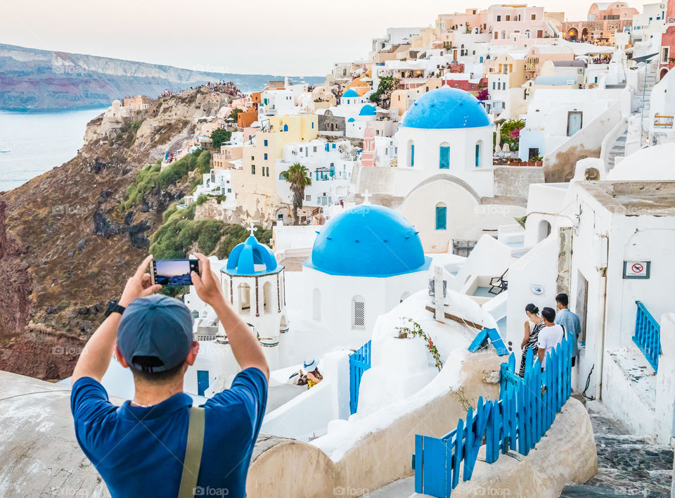 Tourist Taking Photo With Smartphone In Famous Greek Island Santorini
