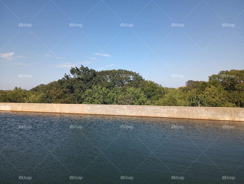 Water Treatment plant basin with trees in background, cool colors and unique photo for realz