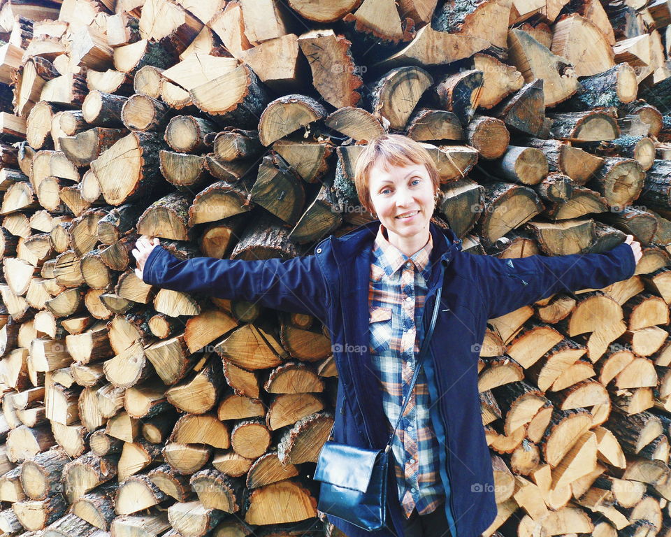 girl on the background of firewood