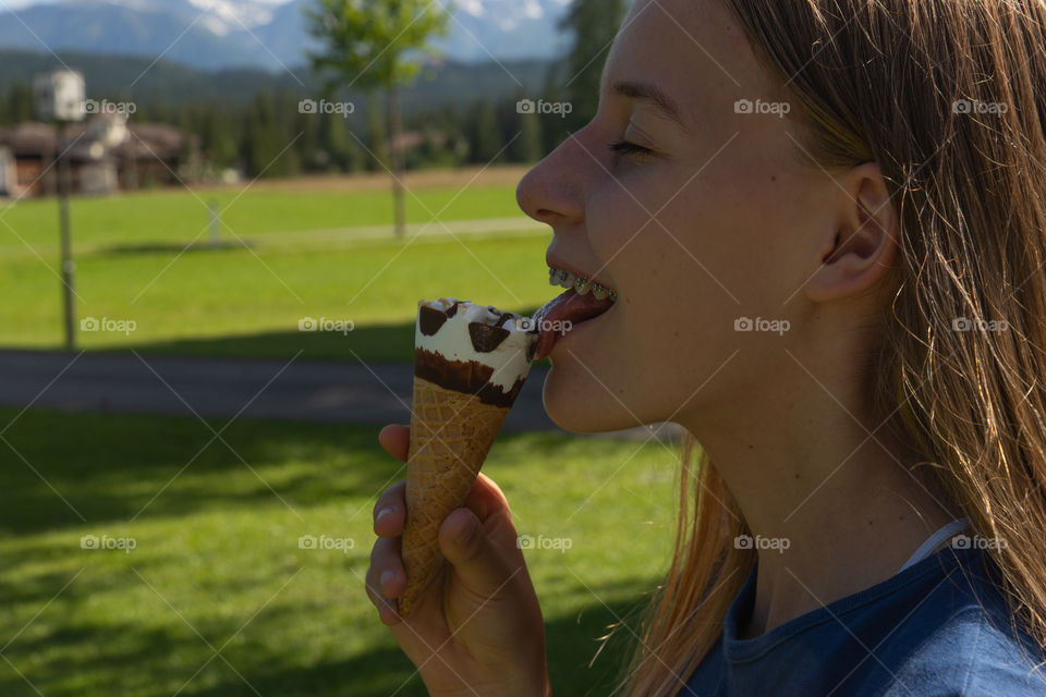 girl eats an ice cream in summer