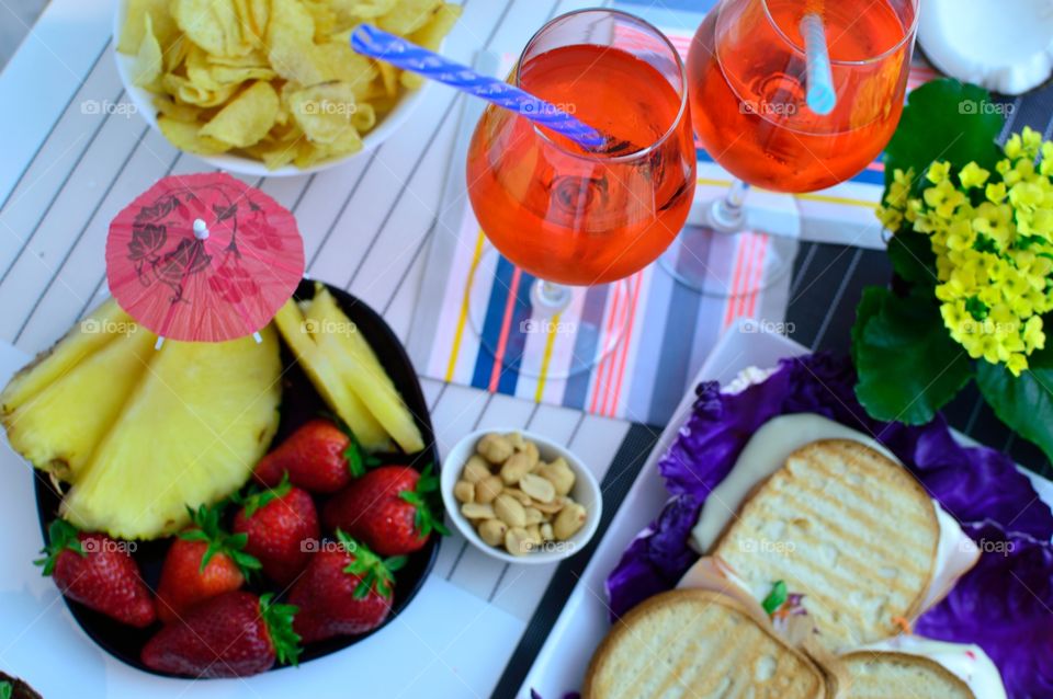 summer aperitif with fruit, drink and snacks