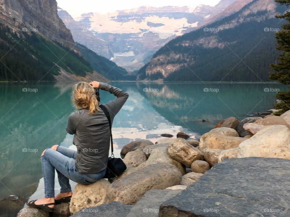 Female Foaper (me) photographing beautiful and majestic Lake Louise in Banff National Park, Alberta Canada in the early morning 