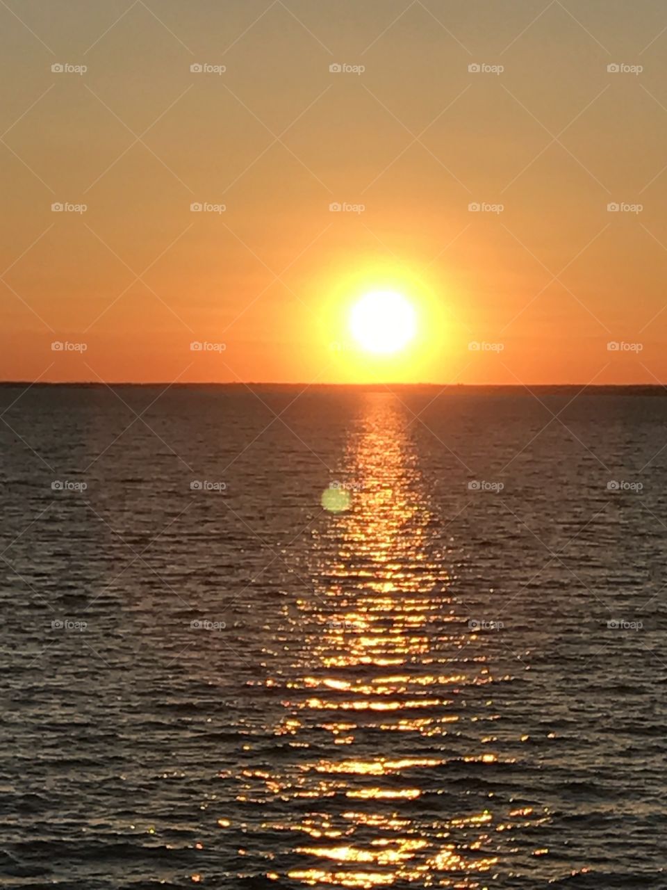 Sunset on the ocean, yellow glow 