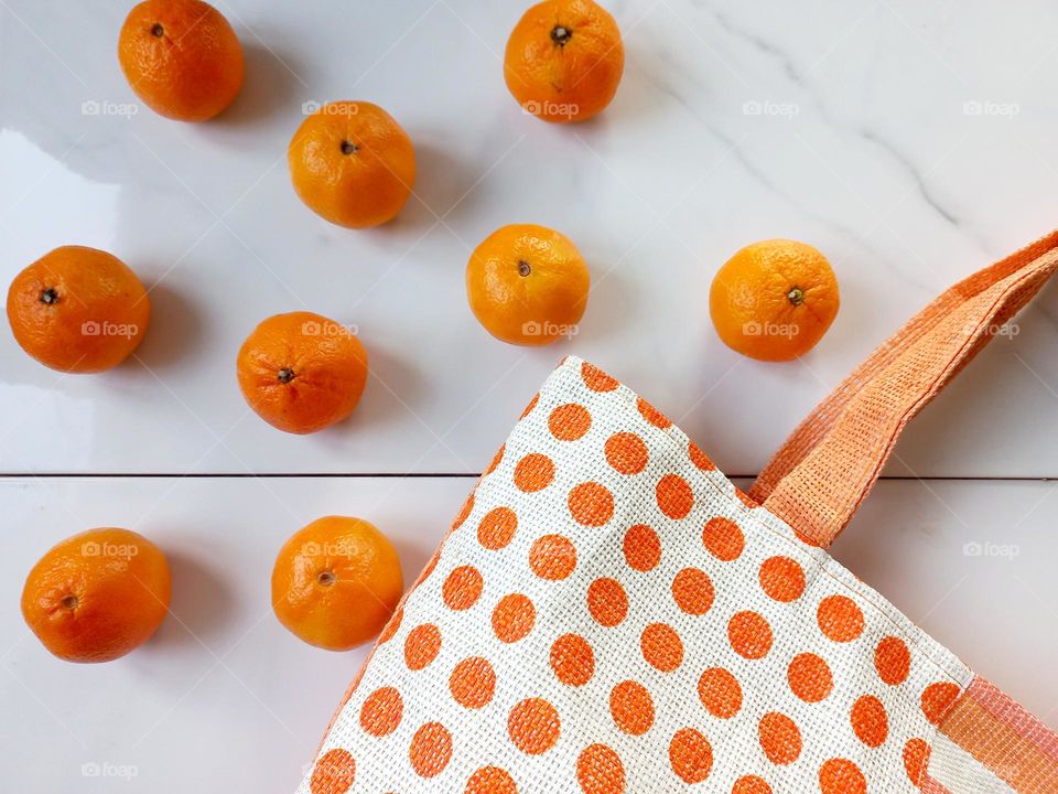 round tangerines with a bag