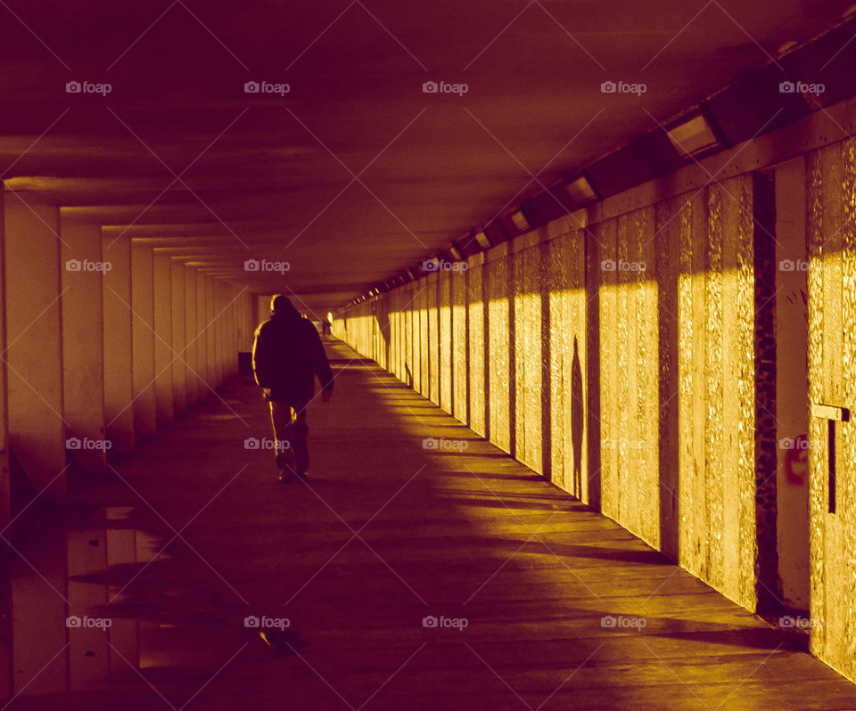 A man walks along Bottle Alley, a seafront, pedestrian underpass in Hastings