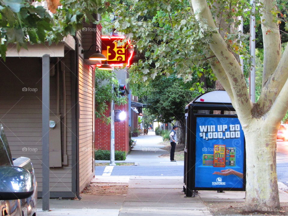 sidewalk view of a man standing at the corner