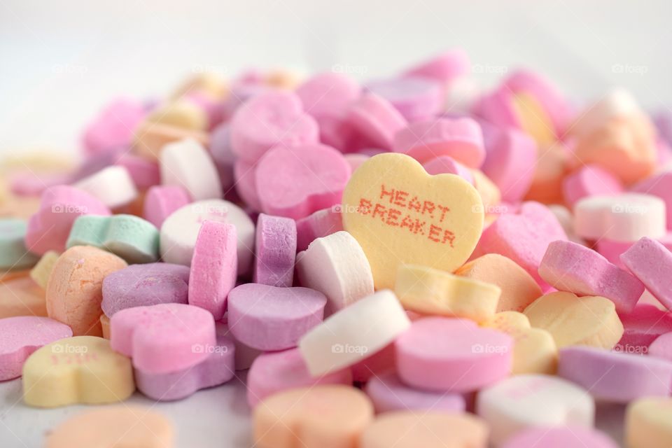 Pile of Valentine’s Candy Hearts on a White Background 