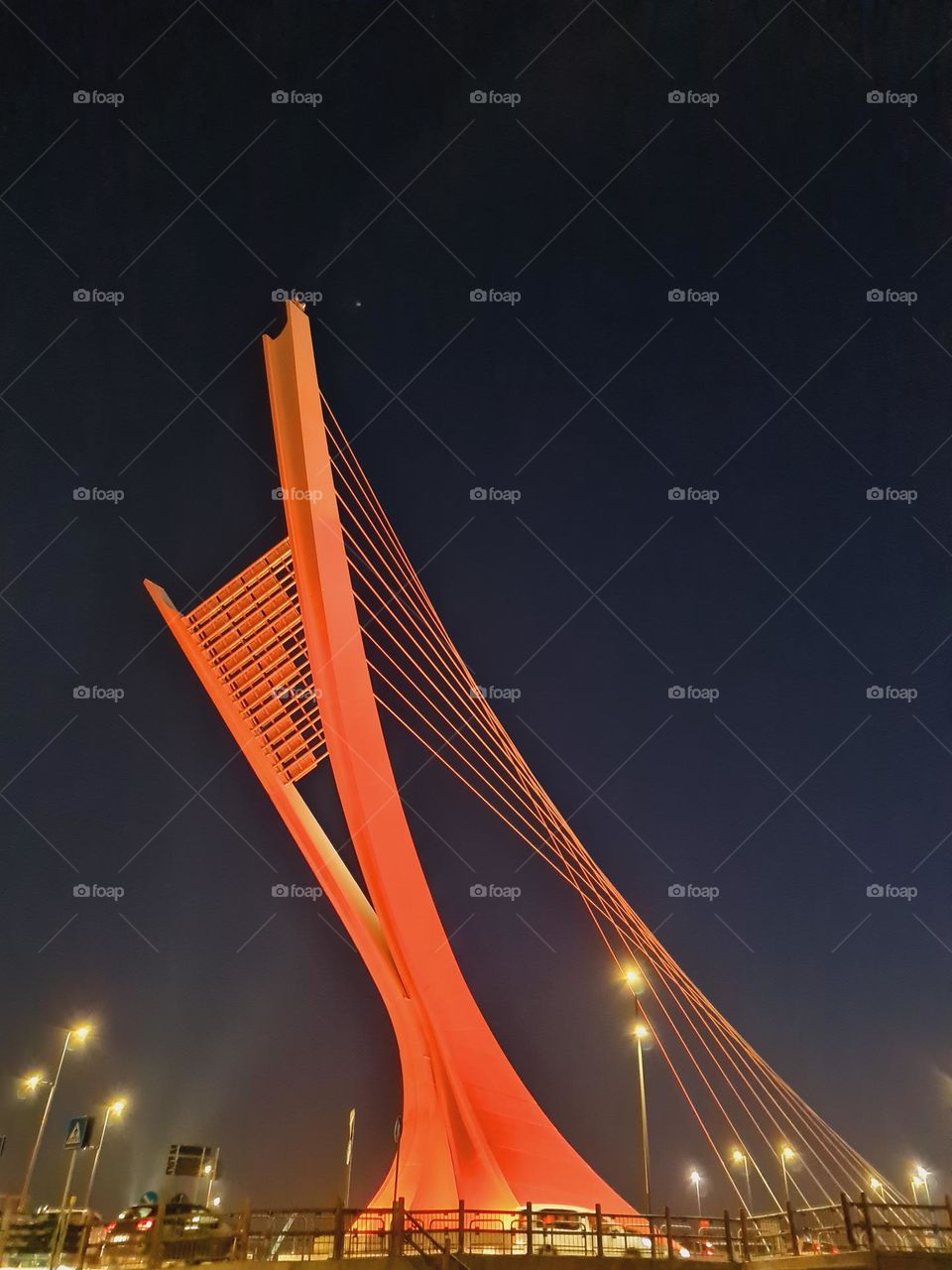 futuristic and red-lit structure of a bridge