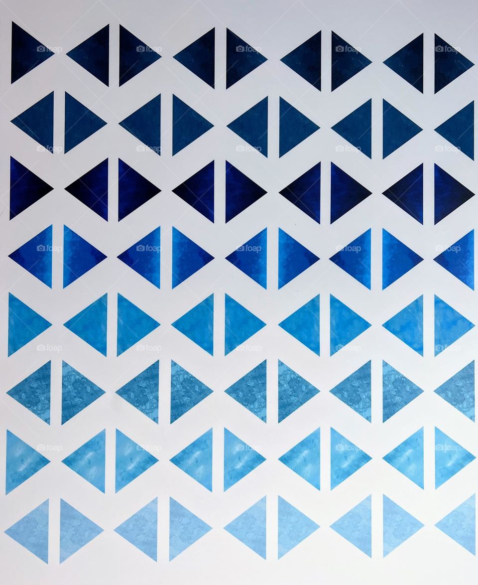 Triangles in geometrical shape order in a plenty of blue shades