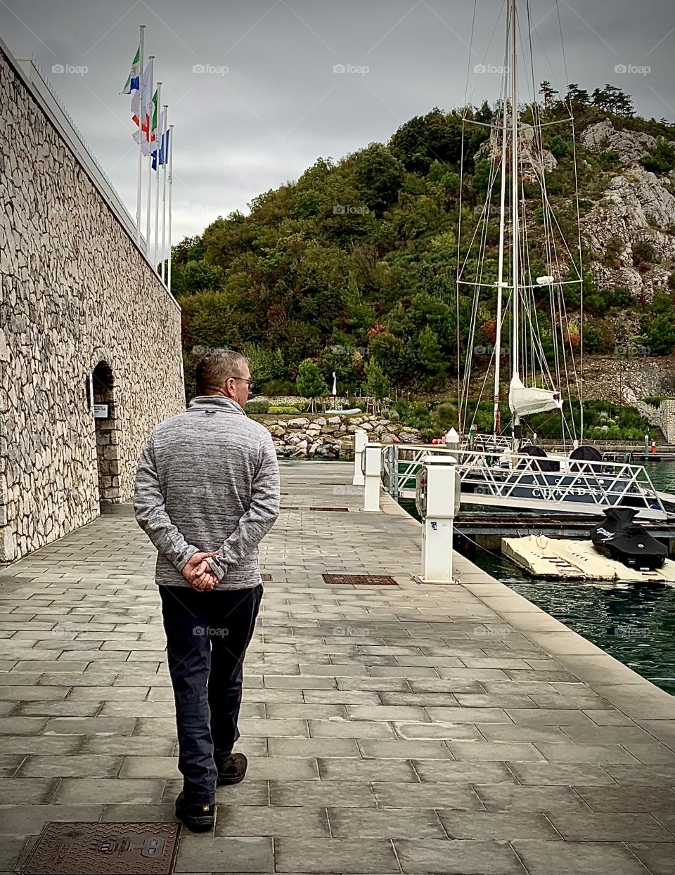 Senior Man walking by the boat docks