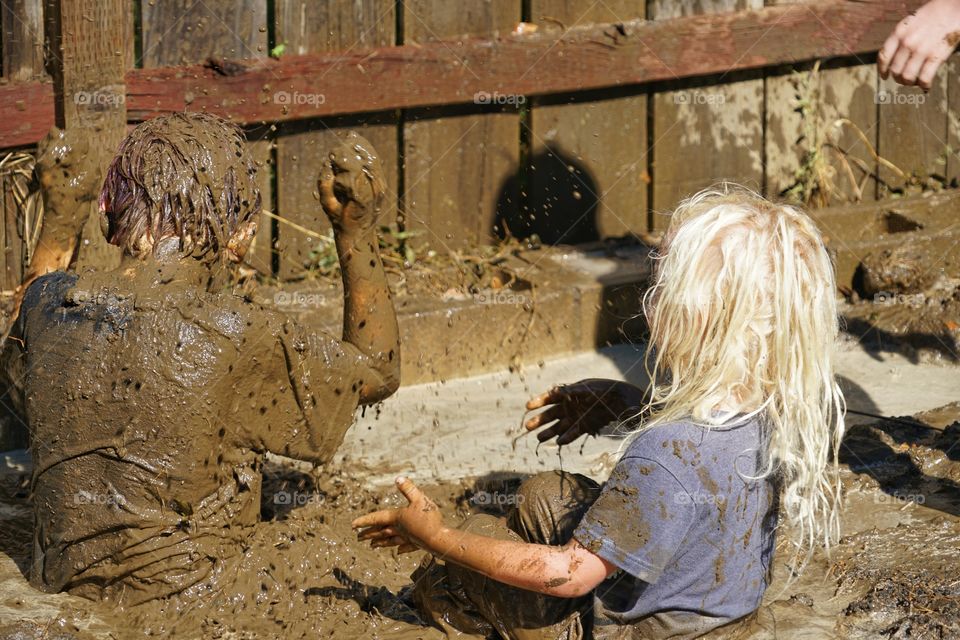 Boys Playing In The Mud