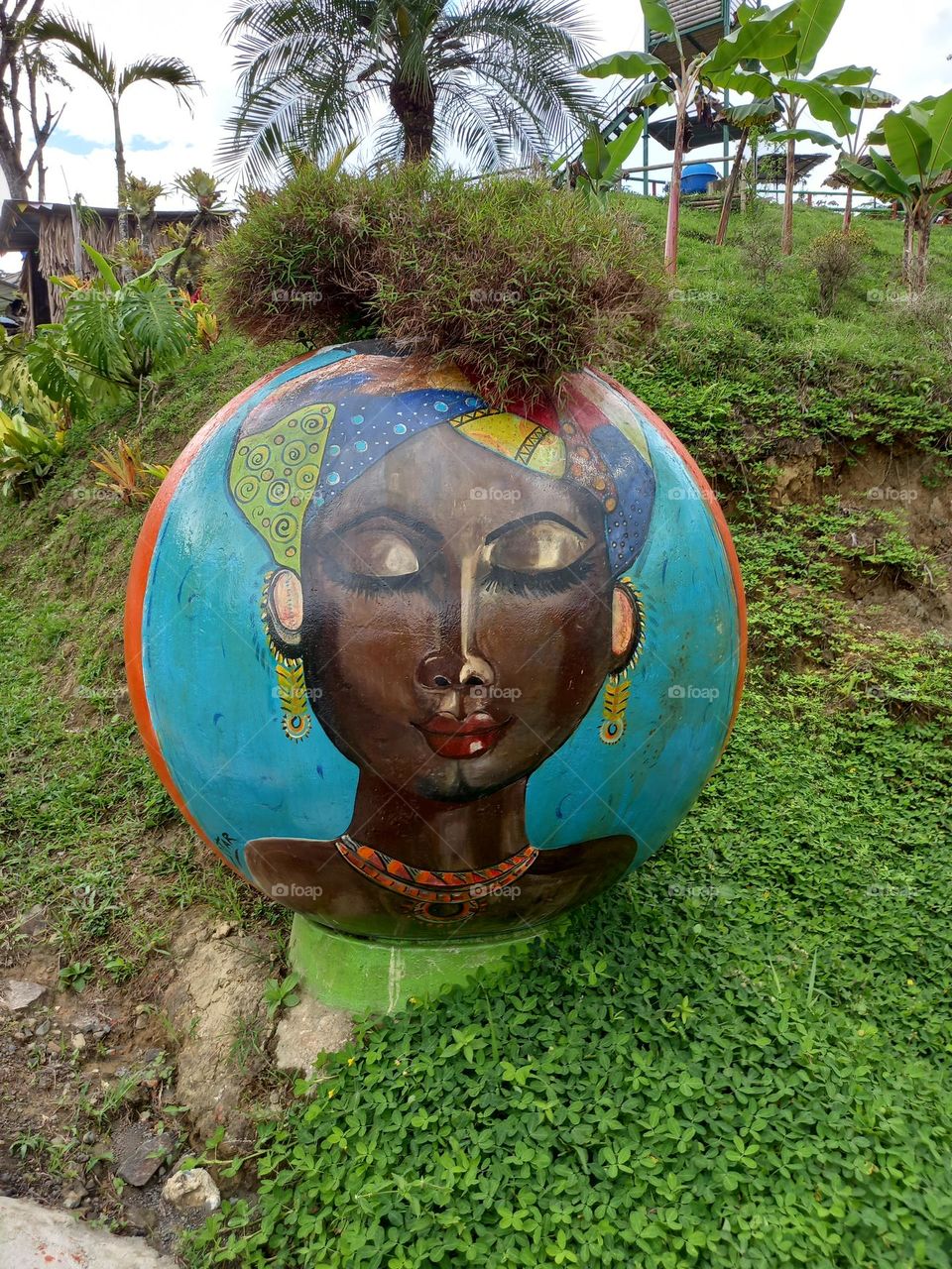 woman painting on a stone