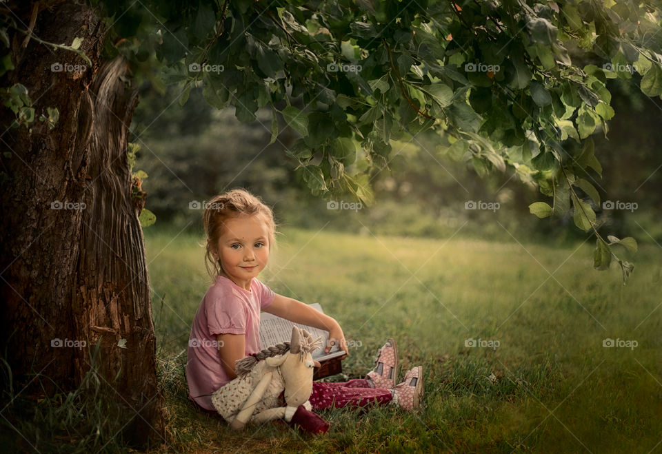 Girl reading the book outdoor