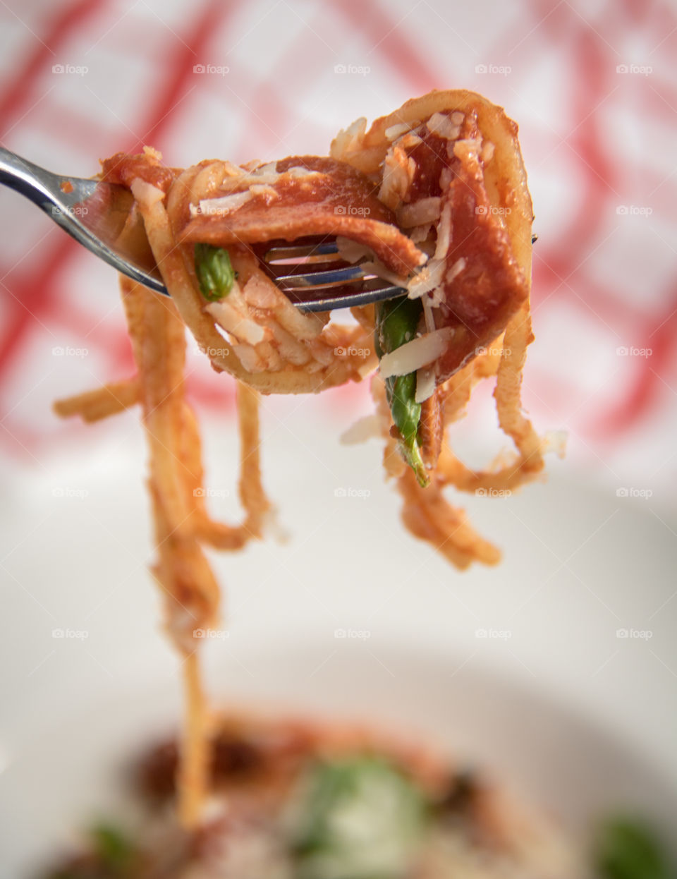 Pepperoni pasta on fork