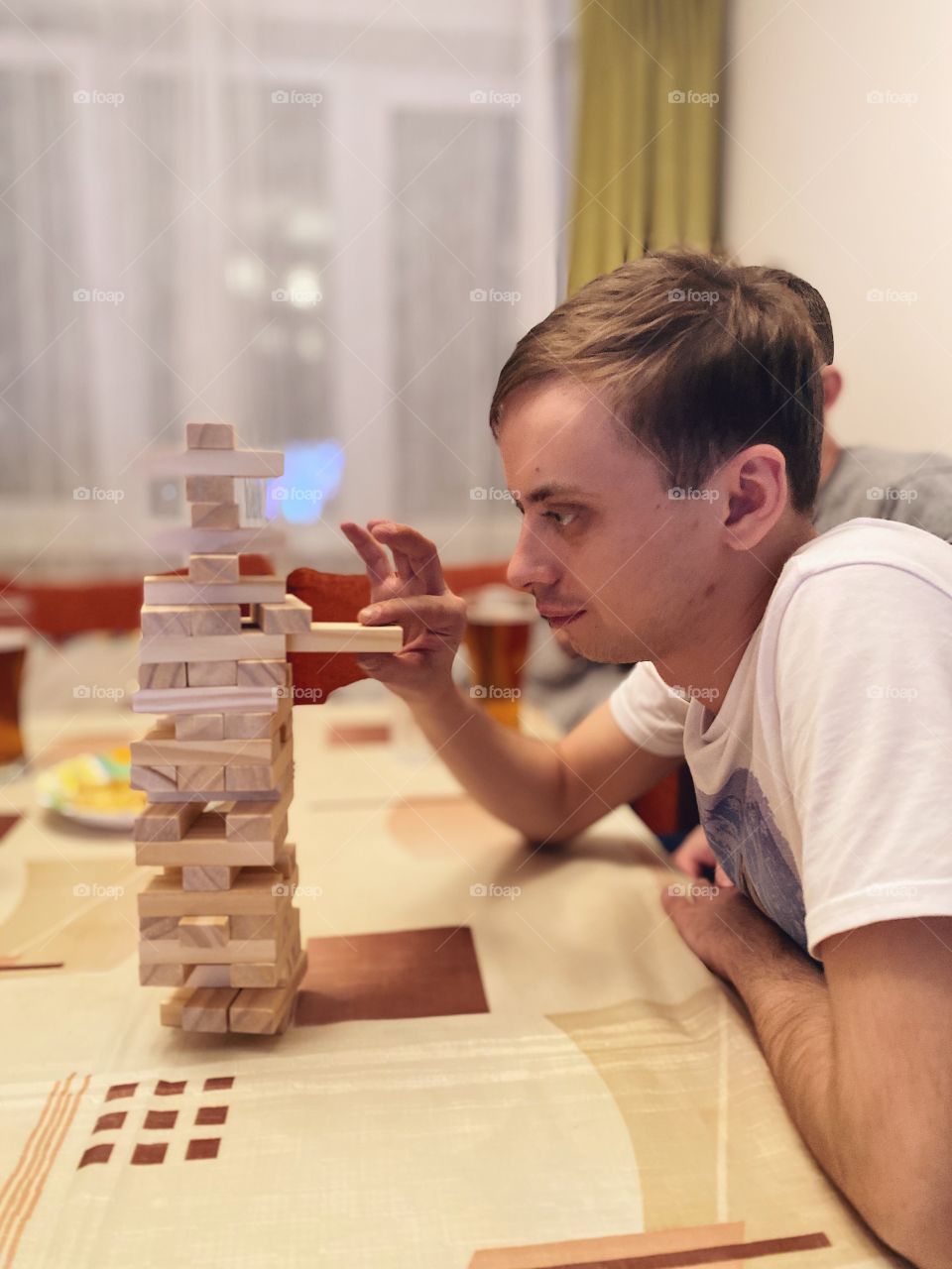 Man playing home game Jenga