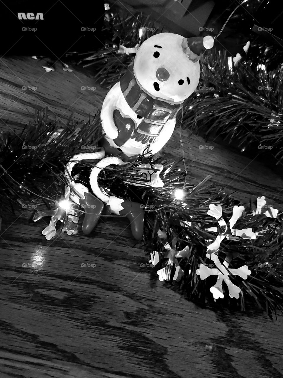 snowman lite up with Christmas lights singing a Carol.