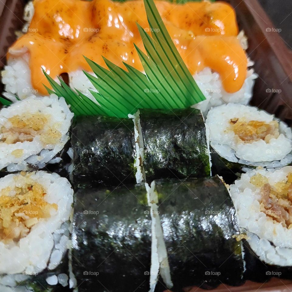 assorted sushi served in a container