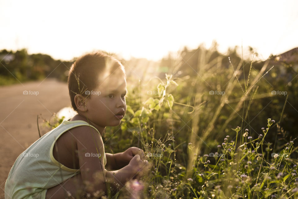 Boy on the road side at golden hour